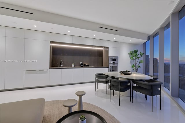 dining space with expansive windows and sink