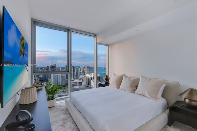 bedroom with light carpet and expansive windows