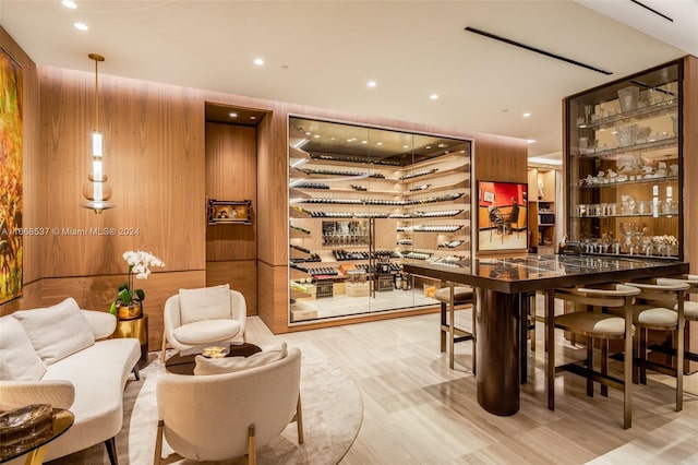 bar with wood walls and hardwood / wood-style flooring