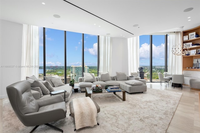 living room with expansive windows, light wood-type flooring, and a wealth of natural light