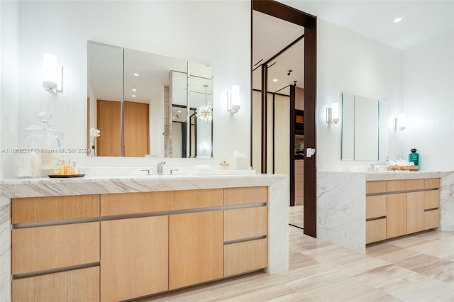 bathroom featuring vanity, a towering ceiling, and hardwood / wood-style floors