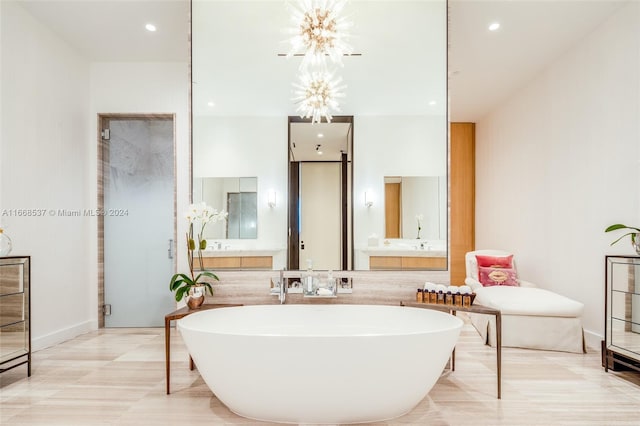 bathroom featuring a tub to relax in, hardwood / wood-style flooring, and vanity