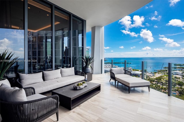 balcony with a water view and an outdoor hangout area