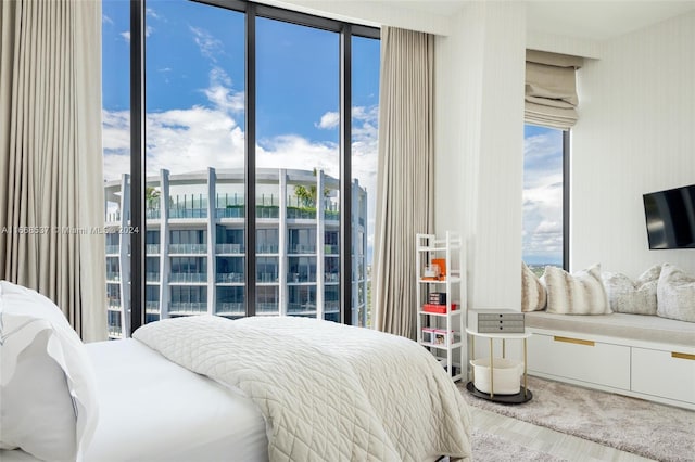 bedroom with carpet and floor to ceiling windows