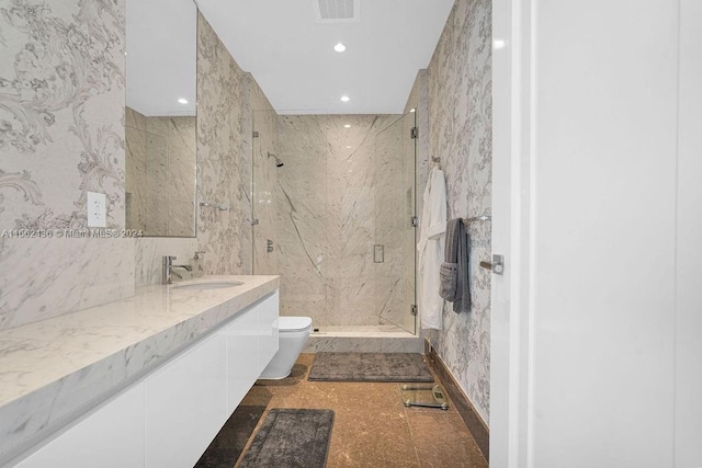 bathroom featuring tile walls, a shower with door, vanity, and toilet