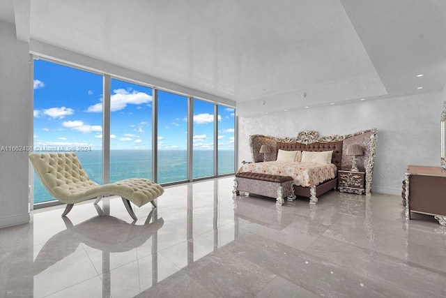 bedroom featuring expansive windows, access to exterior, and a water view