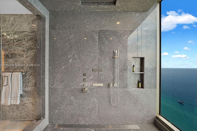 bathroom featuring a shower and a water view