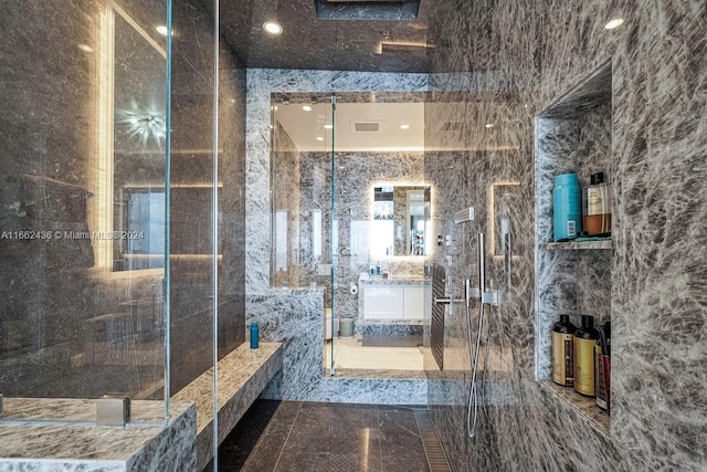 bathroom featuring a shower with shower door and tile walls