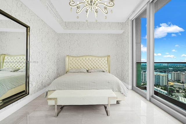 bedroom with a notable chandelier, floor to ceiling windows, and access to exterior