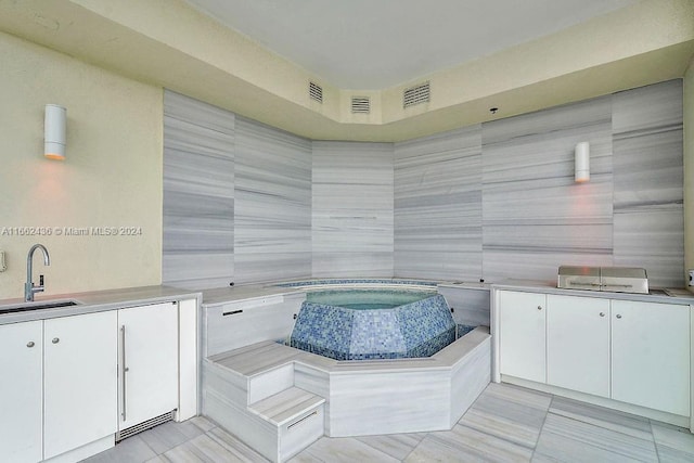 bathroom featuring tile patterned floors, vanity, and tile walls