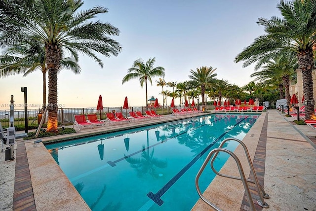 view of pool at dusk