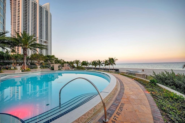 pool at dusk with a water view