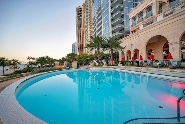 view of pool at dusk