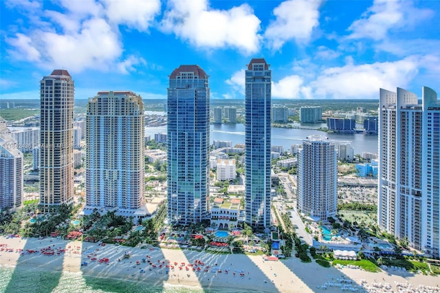 property's view of city with a view of the beach and a water view