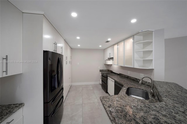 kitchen with black appliances, dark stone countertops, sink, and white cabinets