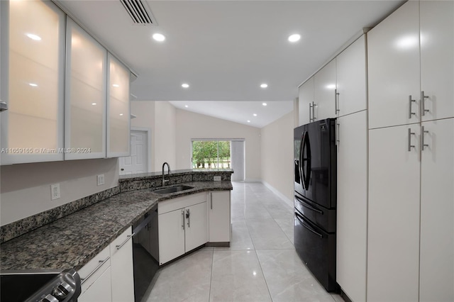 kitchen with sink, lofted ceiling, white cabinetry, black appliances, and dark stone countertops