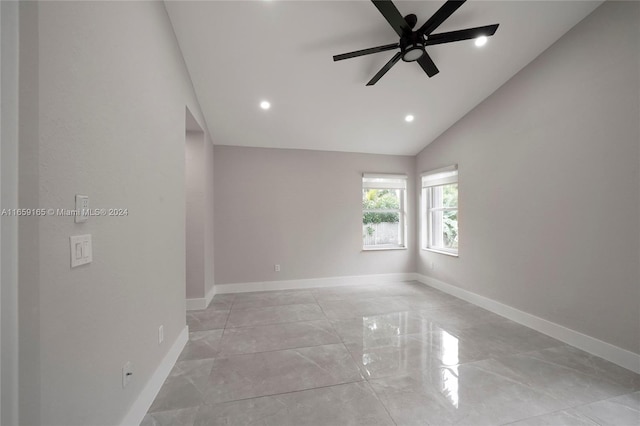 spare room featuring vaulted ceiling and ceiling fan