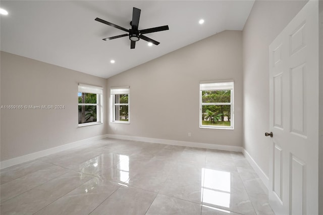 empty room with lofted ceiling, ceiling fan, and a healthy amount of sunlight