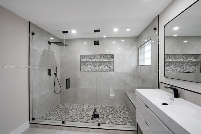 bathroom with walk in shower and vanity