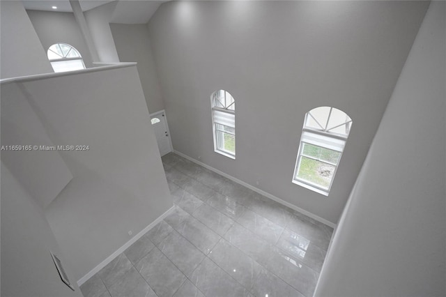 tiled foyer entrance featuring a high ceiling