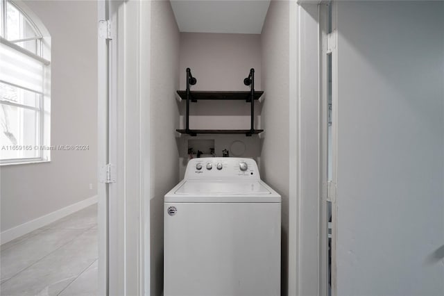 washroom featuring washer / clothes dryer, laundry area, and baseboards