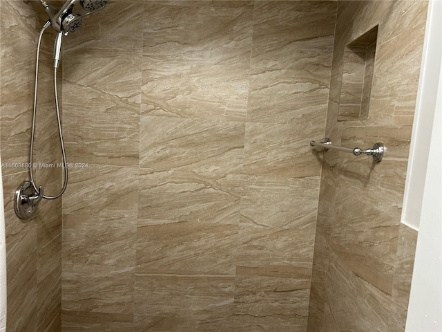 interior details with a tile shower