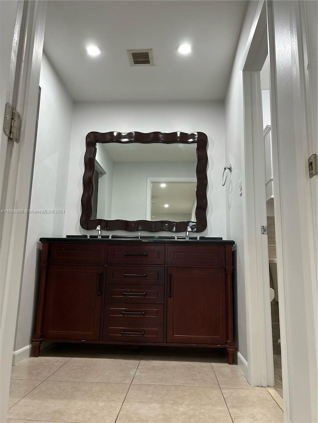 bathroom with vanity, toilet, and tile patterned floors