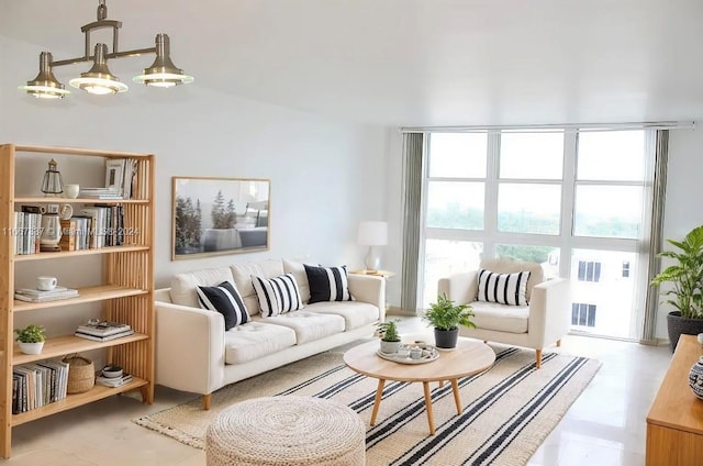 living room with light tile patterned floors, an inviting chandelier, and plenty of natural light