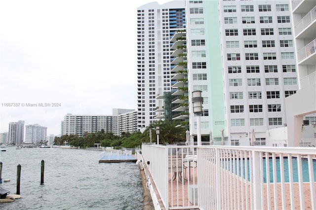 exterior space with a community pool and a water view