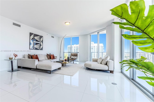 living room featuring light tile patterned flooring and a wall of windows