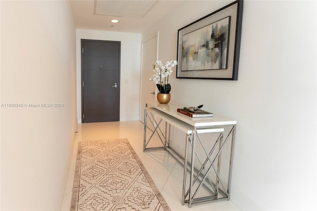 hall with light tile patterned floors