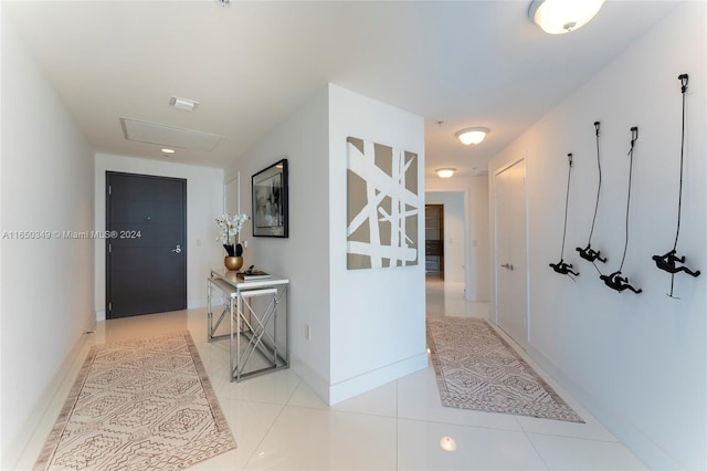 hallway featuring light tile patterned floors