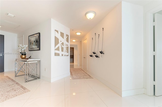 hallway with tile patterned flooring