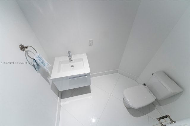 bathroom with tile patterned flooring, vanity, and toilet