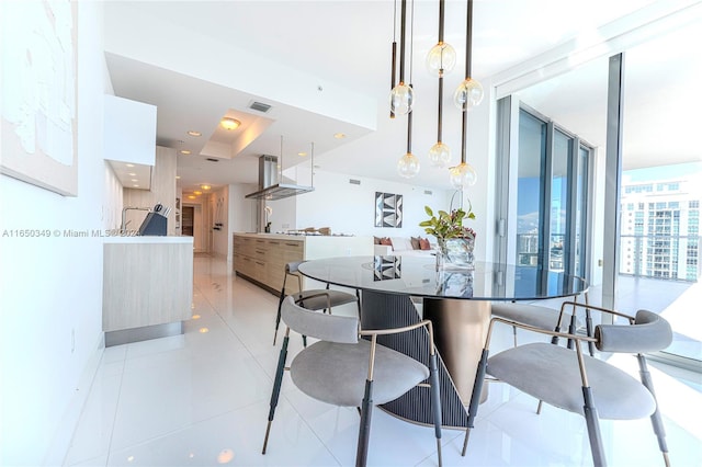 tiled dining space with a wall of windows