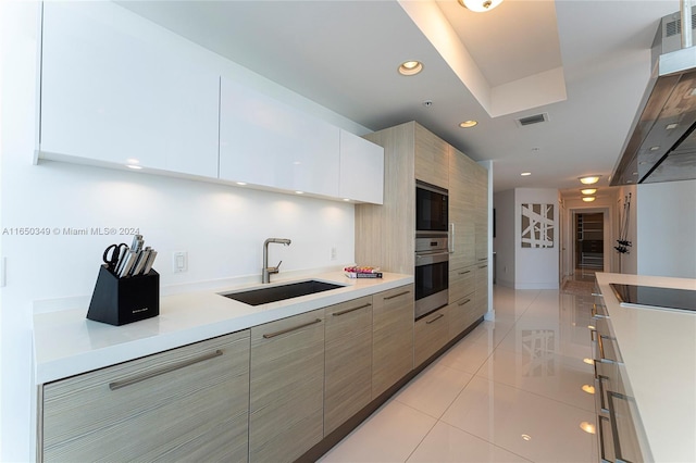 kitchen featuring light tile patterned flooring, sink, and black appliances