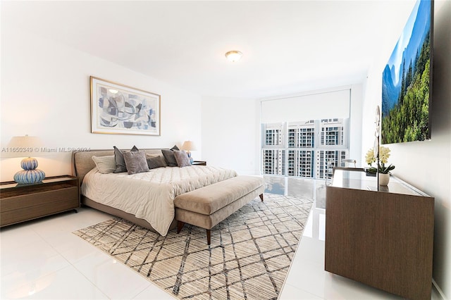 tiled bedroom featuring a wall of windows