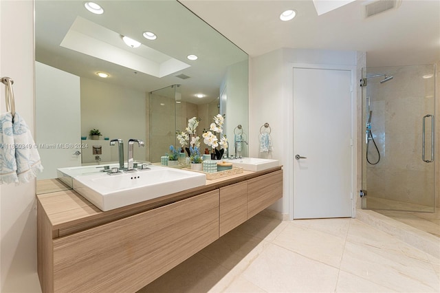 bathroom with vanity, tile patterned floors, and a shower with door