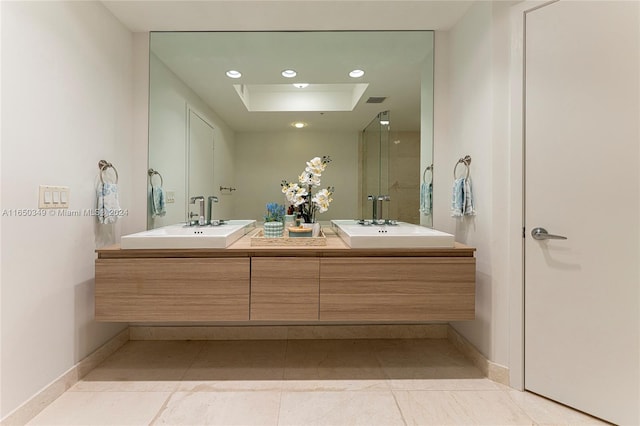 bathroom with tile patterned flooring, a tray ceiling, and vanity