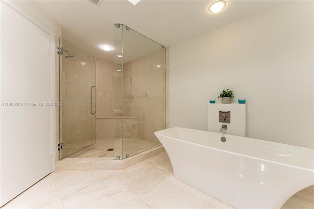 bathroom with shower with separate bathtub