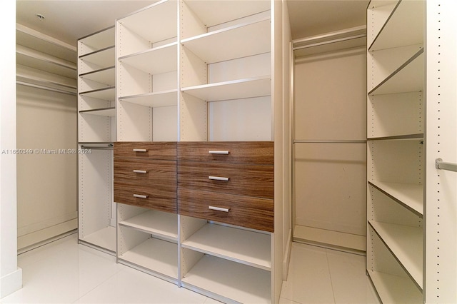 spacious closet with light tile patterned flooring