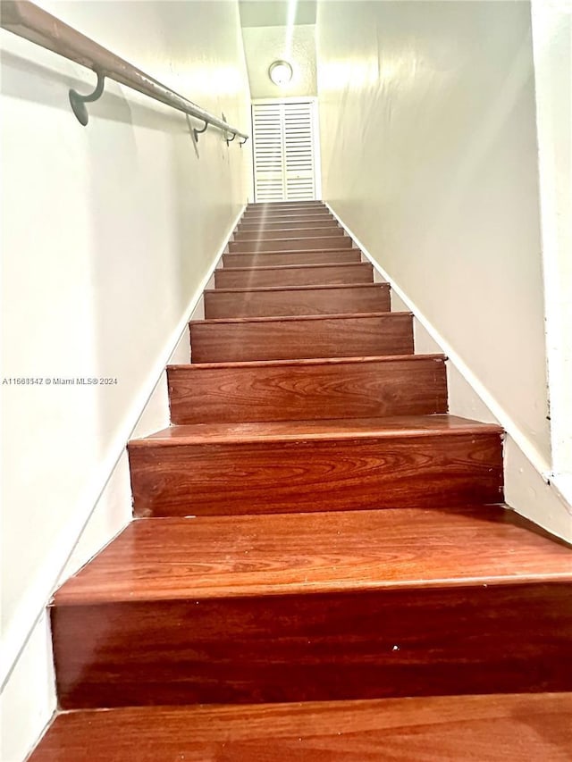 stairs with hardwood / wood-style floors