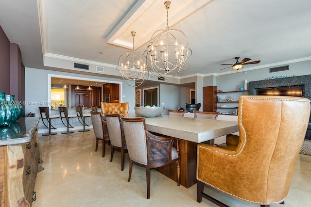 dining space featuring ceiling fan with notable chandelier and ornamental molding