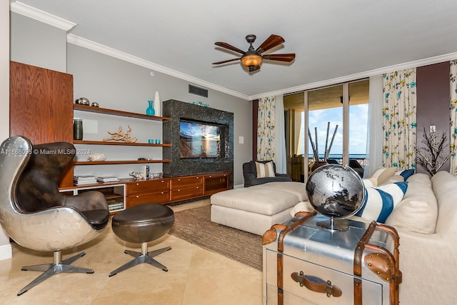 tiled living room featuring ornamental molding and ceiling fan