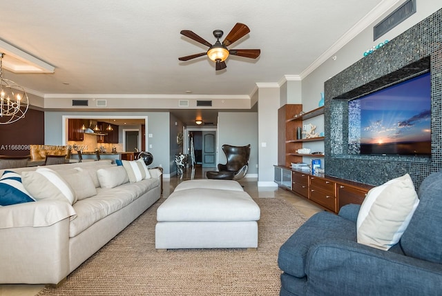 living room featuring ceiling fan with notable chandelier and ornamental molding