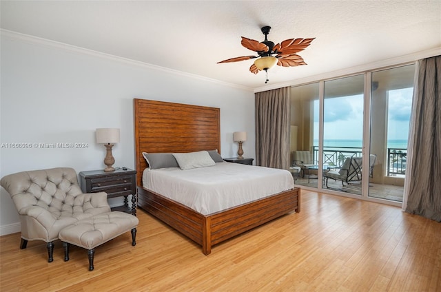 bedroom featuring ceiling fan, light hardwood / wood-style flooring, crown molding, and access to exterior