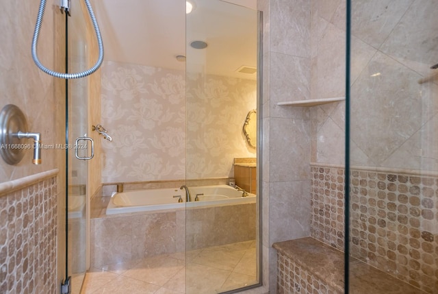 bathroom featuring separate shower and tub