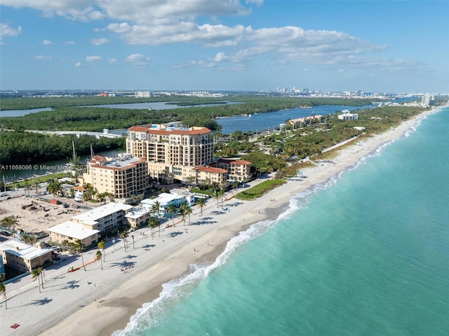 birds eye view of property featuring a water view and a beach view