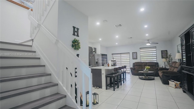 interior space featuring tile patterned flooring and ceiling fan