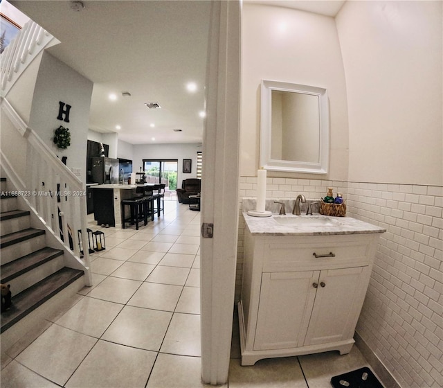 interior space featuring tile walls, tile patterned floors, and sink